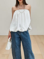 White bubble hem strapless blouse with elasticized neckline and voluminous silhouette.