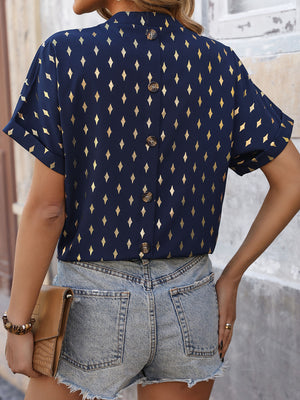 Dark blue short sleeve blouse with gold diamond print and button back detail.