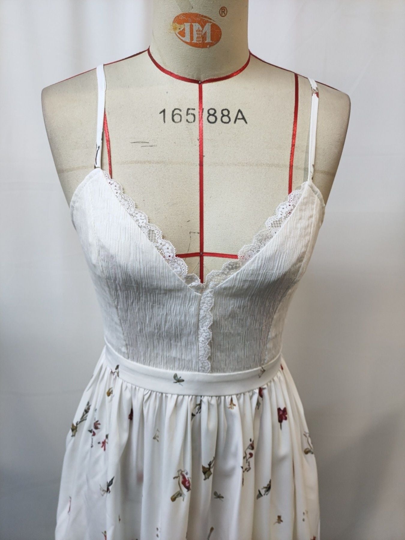 White floral lace trim cami dress with spaghetti straps and a V-neck.