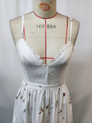 White floral lace trim cami dress with spaghetti straps and a V-neck.