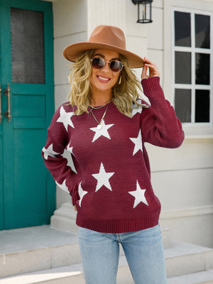 Burgundy crewneck sweater with white stars, long sleeves, ribbed cuffs and hem.