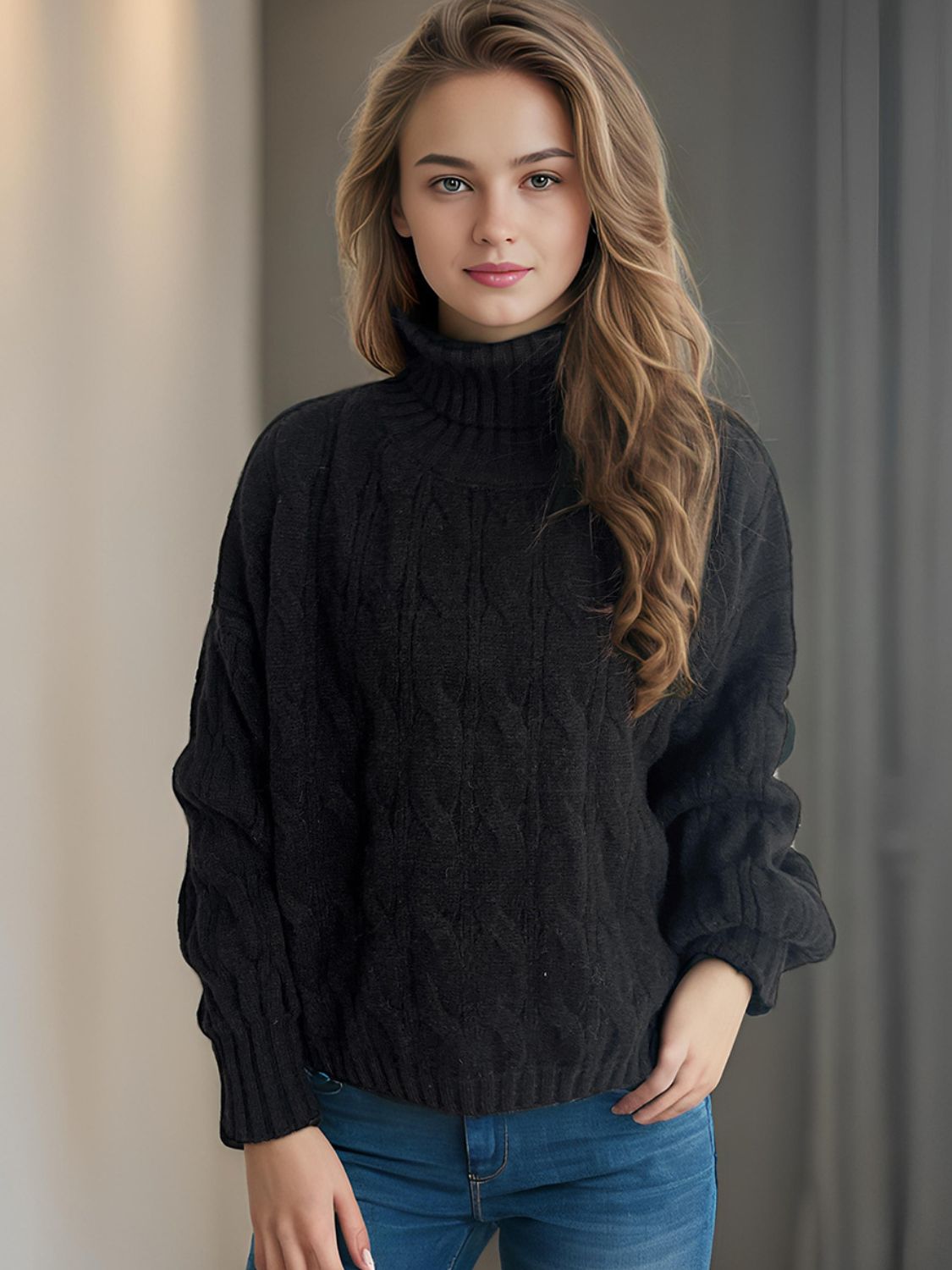Black oversized cable knit turtleneck sweater with textured pattern
