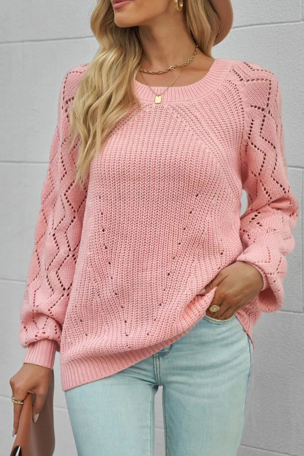 Dusty pink knit sweater with hollow-out puffy sleeves and diamond pattern detail.
