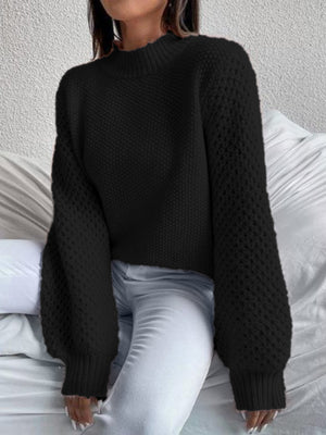 Black textured puff sleeve mock neck knit sweater with balloon sleeves.