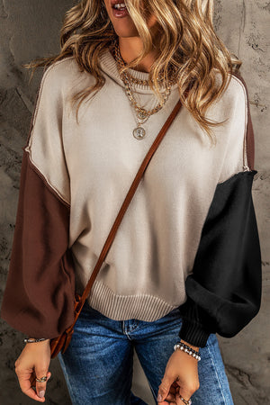 Colorblock knit sweater with balloon sleeves and a cowl neck, in beige, brown, and black.