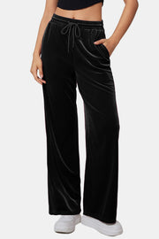 Black velvet palazzo lounge trousers with drawstring waist and pockets.