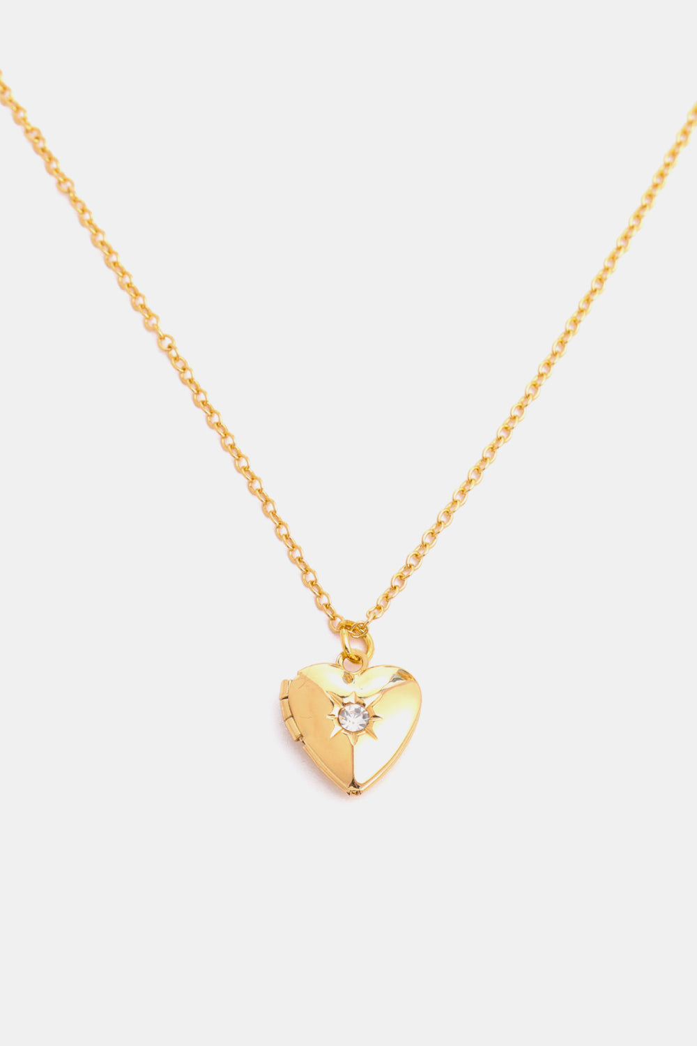 Gold heart locket necklace with a clear gemstone accent and a delicate chain.
