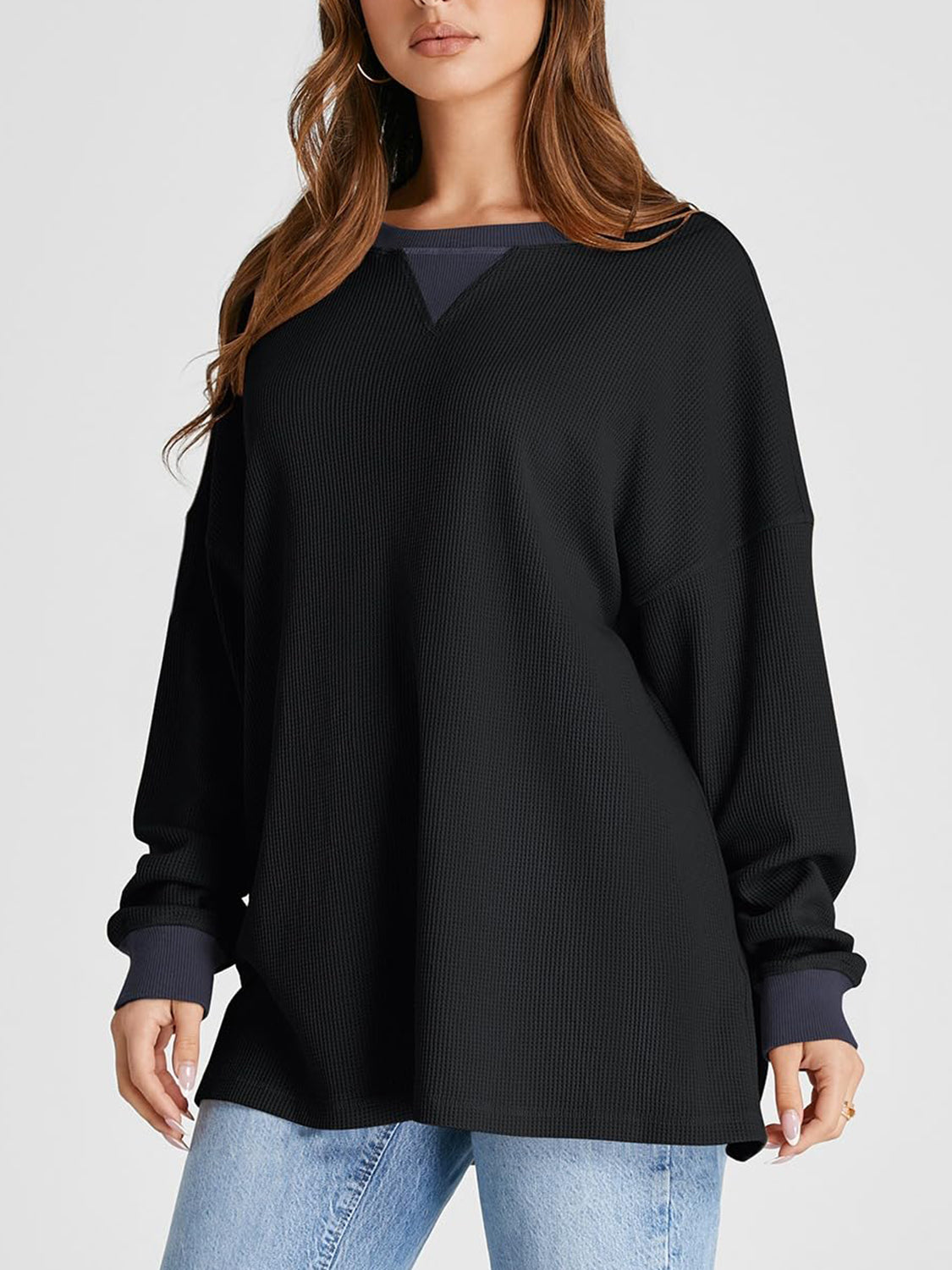 Black waffle knit raglan sleeve sweatshirt with contrast neckline and cuffs.