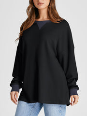 Black waffle knit raglan sleeve sweatshirt with contrast neckline and cuffs.