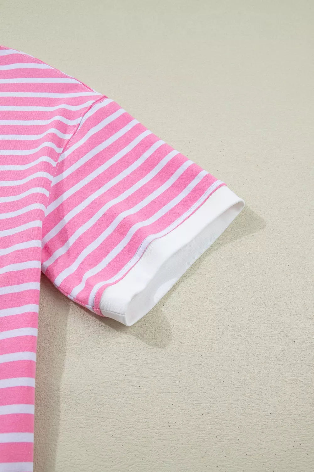 Pink and white striped cotton t-shirt with short sleeves and a white cuff detail.