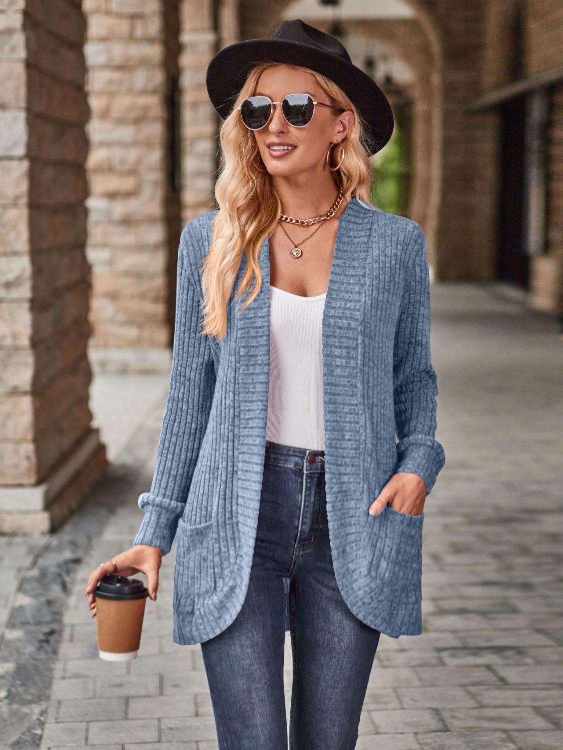 Light blue ribbed open-front cardigan with pockets, styled casually with jeans.