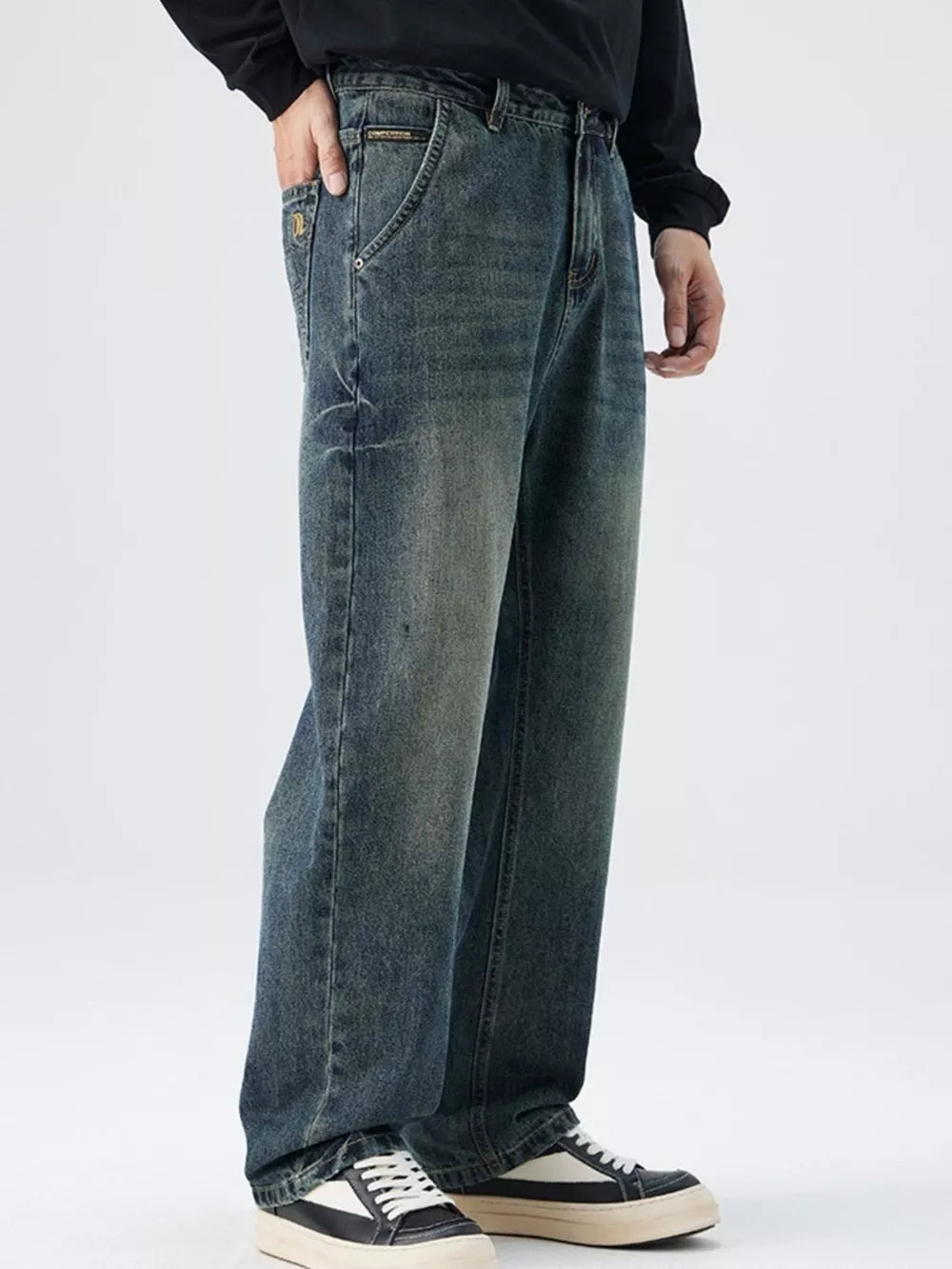 Men's relaxed fit vintage wash denim jeans with distressed details.