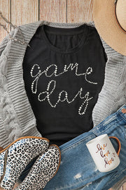Black t-shirt with white dot "Game Day" graphic, crew neck, short sleeves.