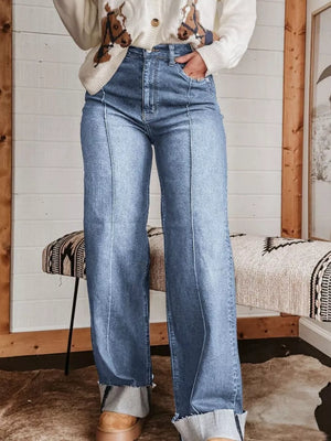 Light blue denim wide-leg jeans with buttoned pockets and cuffed hems.