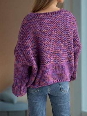 Purple speckled knit sweater with balloon sleeves and a boat neck.