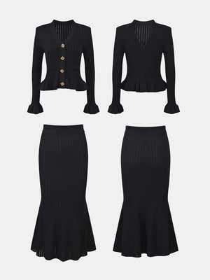 Black knit cardigan with ruffled hem and gold buttons, paired with a matching ribbed midi skirt.