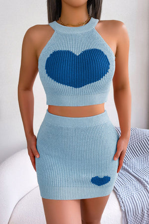 Sky blue knit halter crop top and mini skirt set with intarsia heart detail.