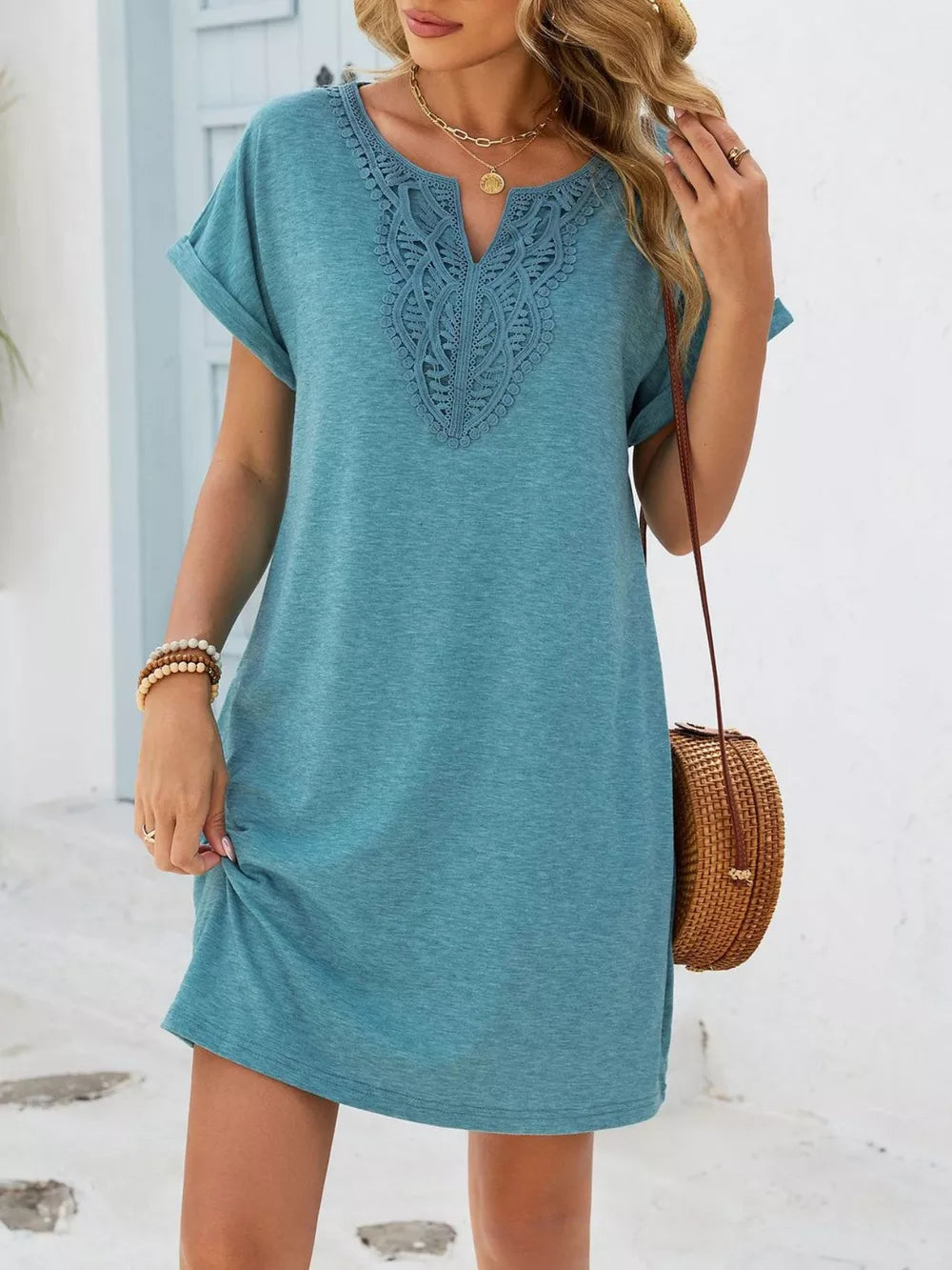 Dusty blue V-neck dress with lace trim and cuffed short sleeves.