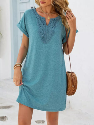 Dusty blue V-neck dress with lace trim and cuffed short sleeves.