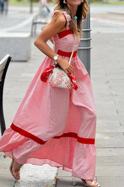 Maxi dress with red and white stripes, bow knot straps, and red trim details.