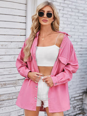 Pink oversized denim shirt with button front and chest pockets.