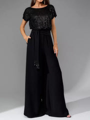 Black sequin short sleeve bodice with a belted palazzo pant ensemble.