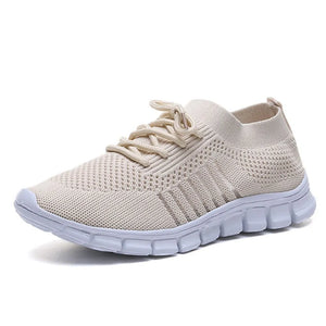 Beige knit runner sneaker with ribbed detail and white sole.