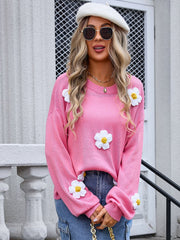 Pink acrylic knit sweater with balloon sleeves and white daisy appliqués.