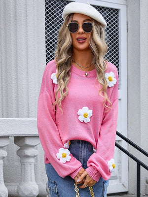 Pink acrylic knit sweater with balloon sleeves and white daisy appliqués.