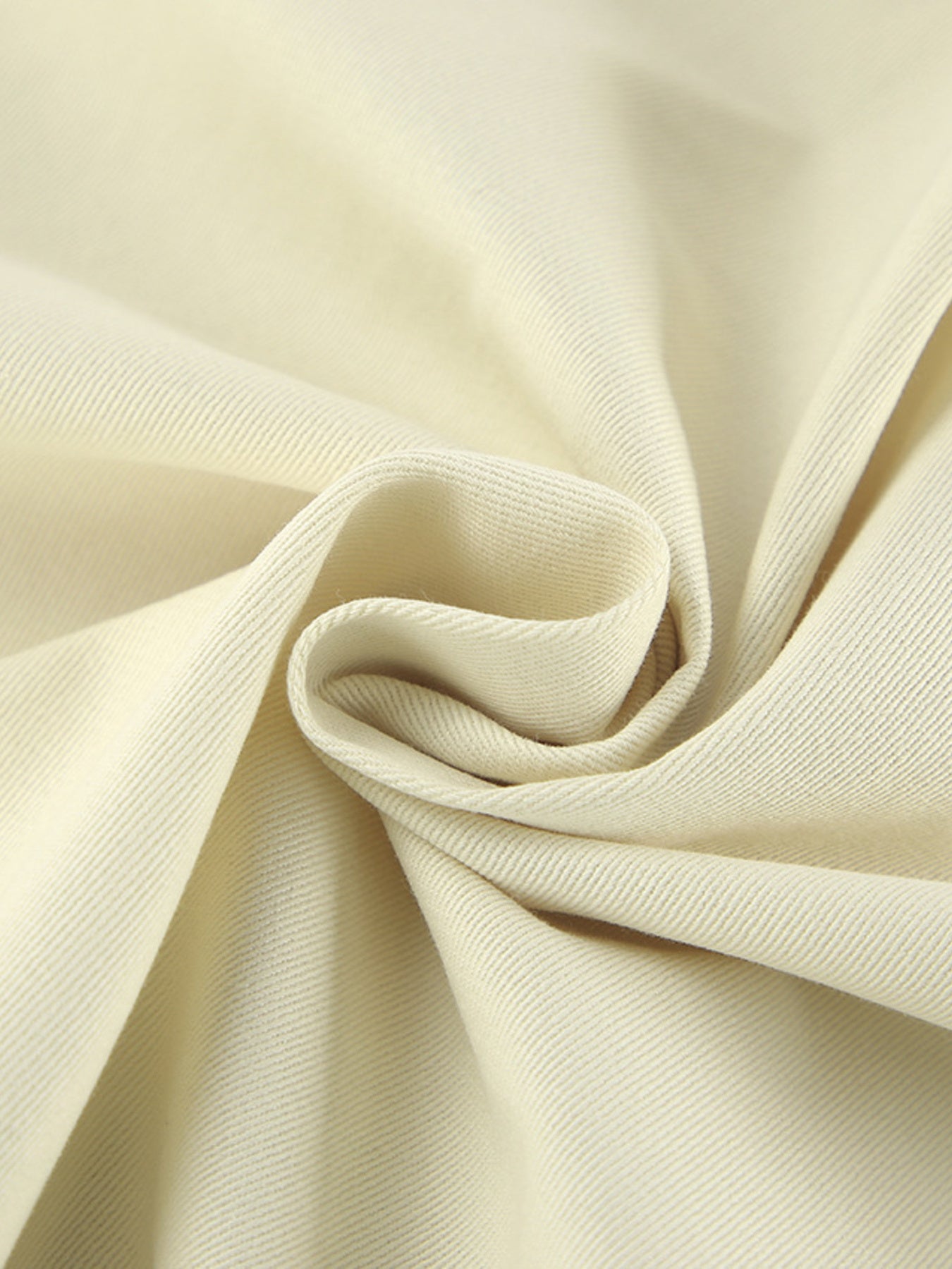 Chic cotton midi skirt in beige with a visible slit detail and subtle ribbed texture.