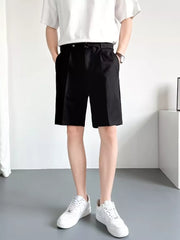 Men's black belted chino shorts with pleats and a relaxed fit.