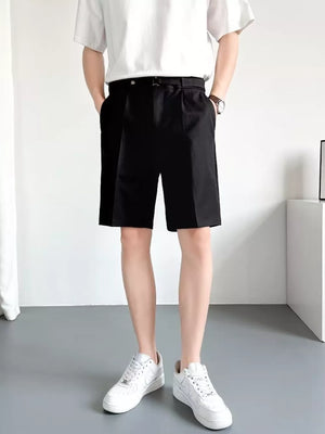 Men's black belted chino shorts with pleats and a relaxed fit.