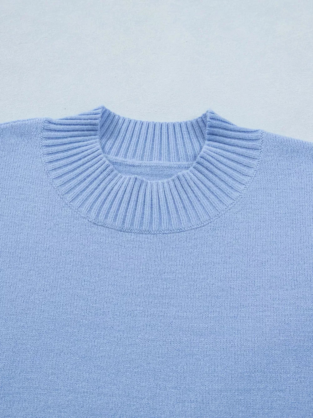Light blue ribbed knit top with ruffled round neck