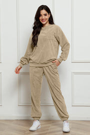Beige corduroy lounge set with crew neck sweatshirt and jogger pants, featuring a chest pocket.