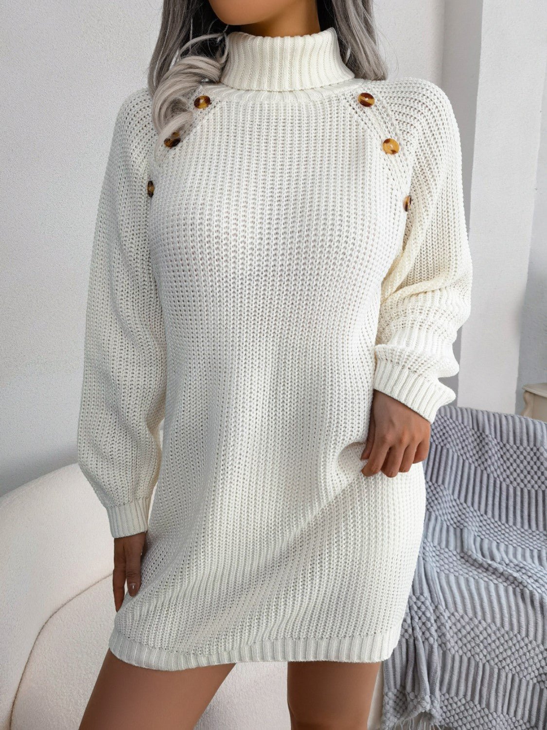 White ribbed knit turtleneck sweater dress with shoulder buttons