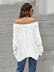 White cable knit off-shoulder sweater with slouchy fit and open knit details.