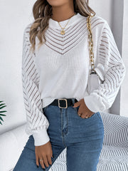 White openwork chevron knit sweater with blouson sleeves and mock neck.