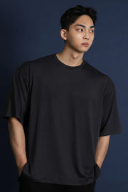 Black oversized crew neck t-shirt with short sleeves and a modern silhouette.