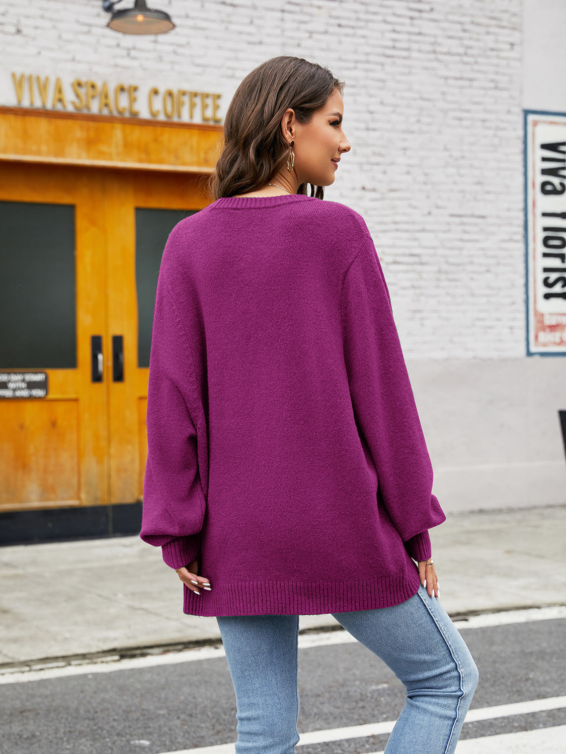 Fuchsia balloon sleeve crewneck knit sweater with ribbed cuffs and hem.