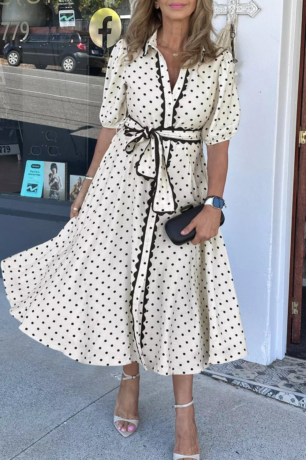 Belted polka dot midi dress with tie belt and ruffled trim.