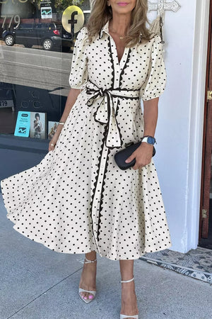 Belted polka dot midi dress with tie belt and ruffled trim.