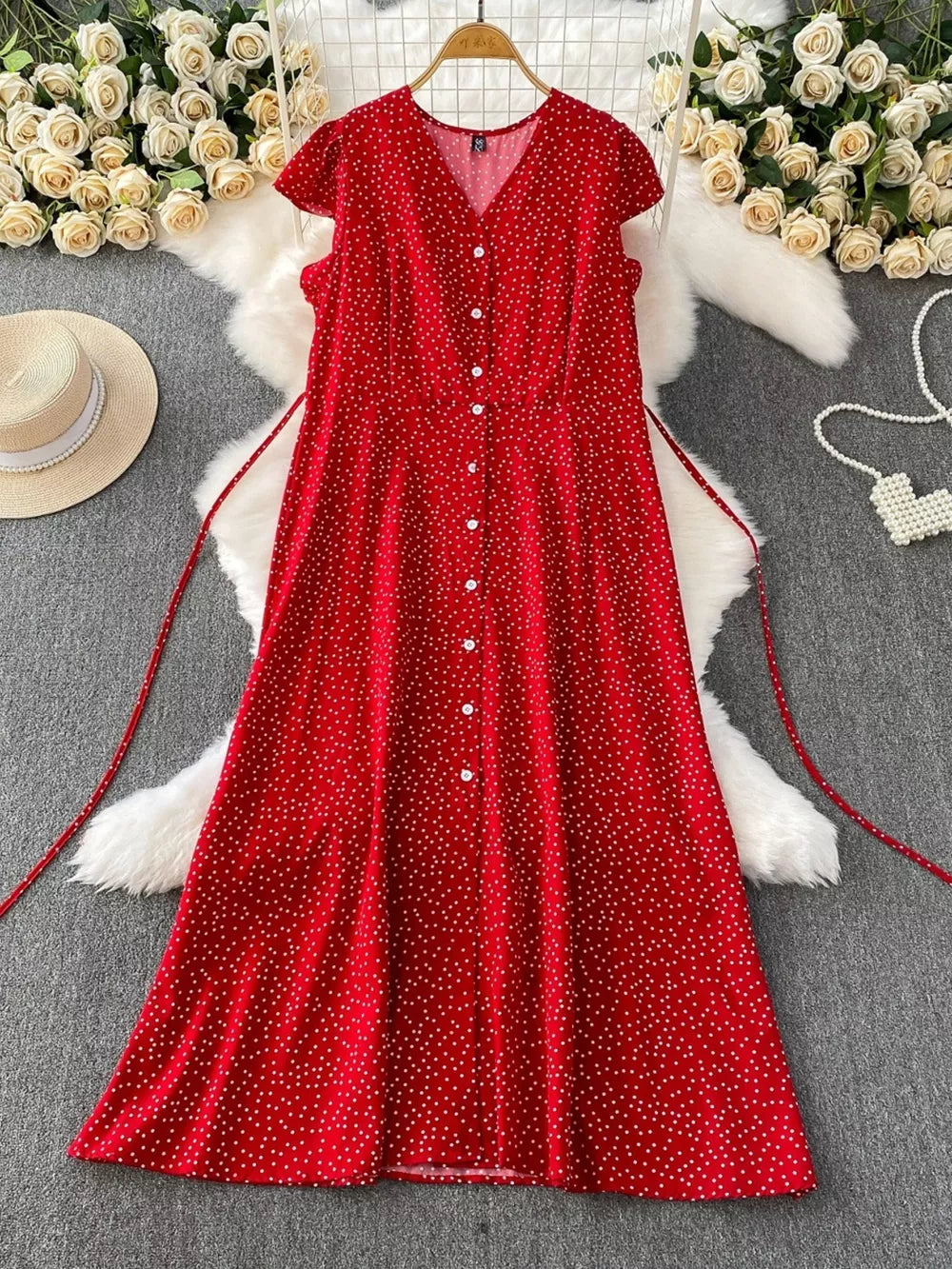 Red polka dot maxi dress with V-neck, short sleeves, button front, and belt.