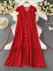 Red polka dot maxi dress with V-neck, short sleeves, button front, and belt.