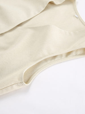 Buttoned vest and shorts set in natural cotton fabric, showing a close-up of the armhole detail.