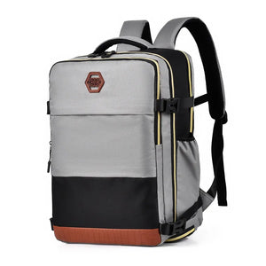 Gray and black travel compartment backpack with contrast panels and brown faux leather trim.