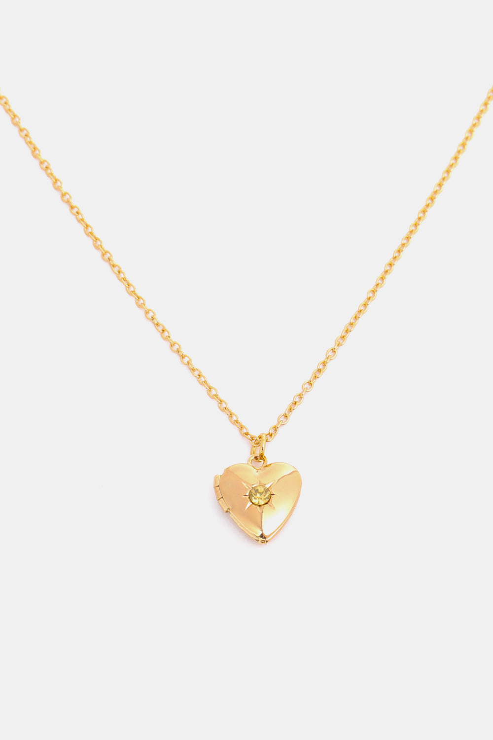 Gold heart locket necklace with a yellow gemstone and 14k gold chain.