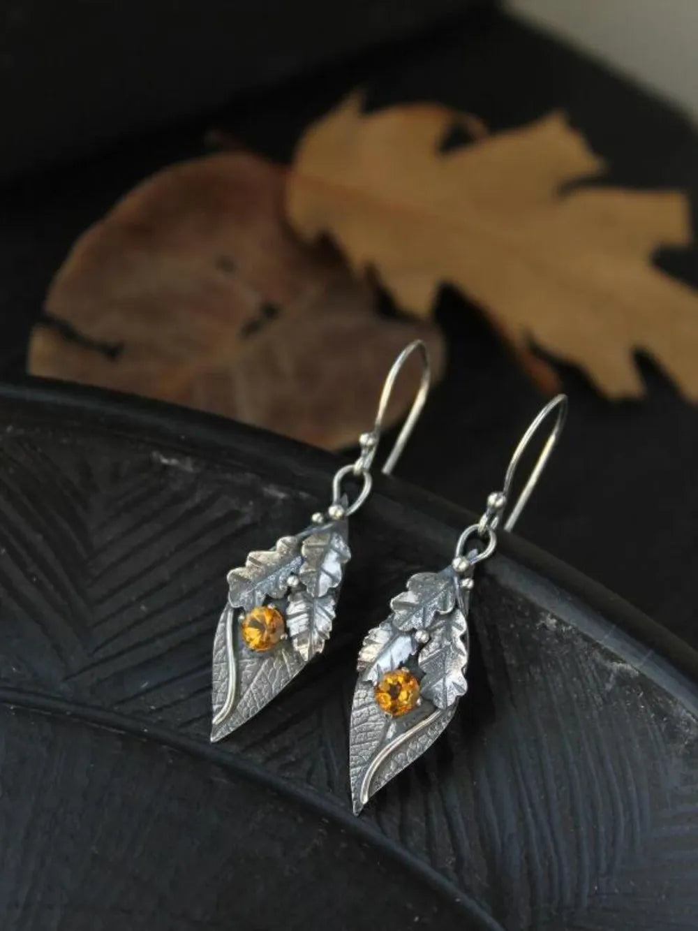 Textured leaf drop earrings with citrine gems and alloy metal.