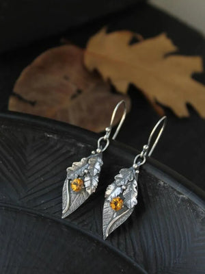 Textured leaf drop earrings with citrine gems and alloy metal.