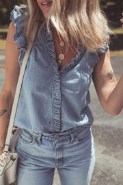 Chambray ruffle trim sleeveless blouse with V-neck and button front detail.