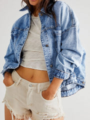 Oversized washed blue denim trucker jacket with button front and chest pockets.